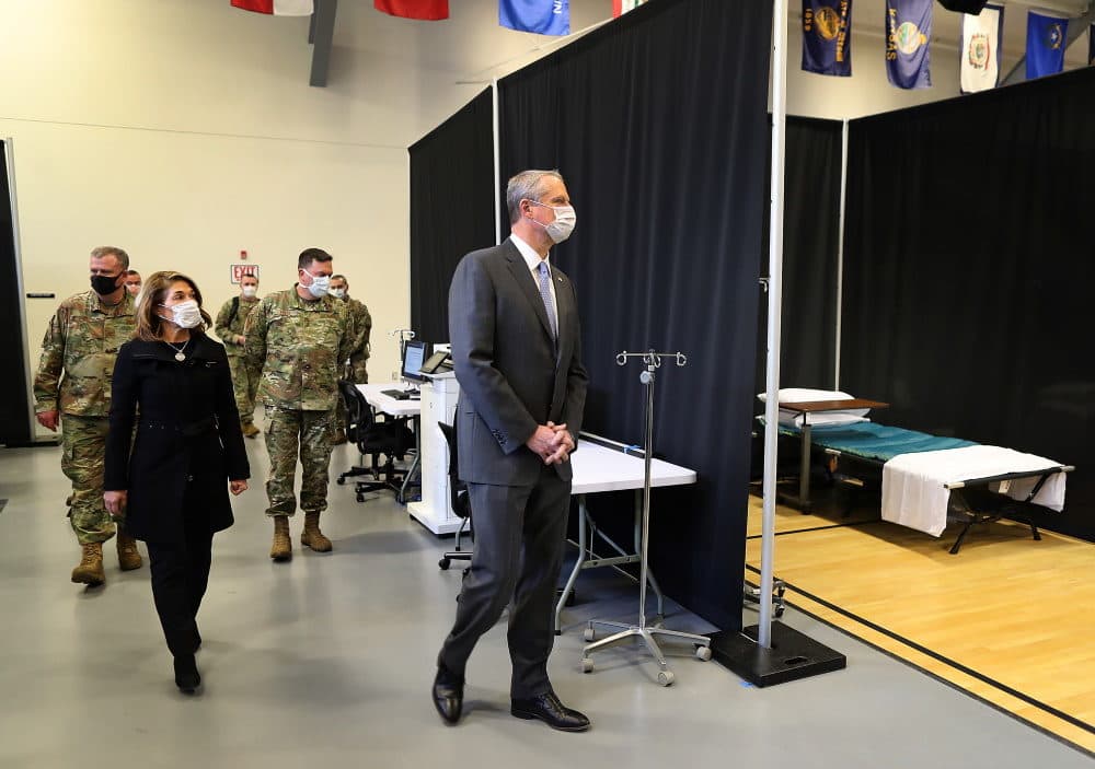 Gov. Charlie Baker and Lt. Gov. Karyn Polito joined the Massachusetts National Guard and Michael Lauf, President and CEO of Cape Cod Healthcare as they toured a field medical station in a gymnasium at Joint Base Cape Cod. (John Tlumacki/Boston Globe via SHNS)
