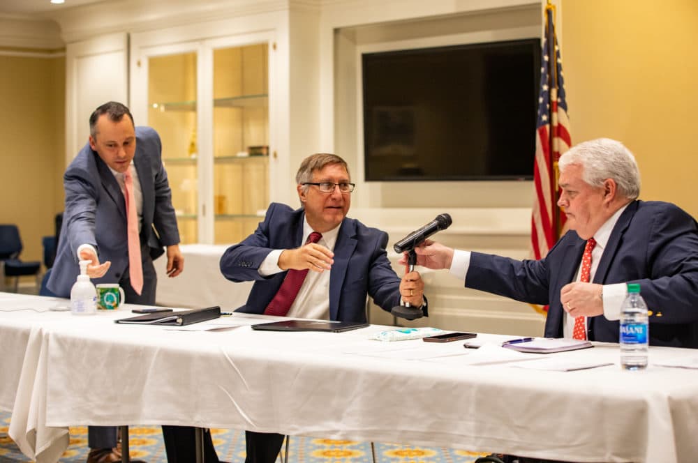 State Rep. Aaron Michlewitz, state Sen. Michael Rodrigues, and Administration and Finance Secretary Michael Heffernan sanitized their hands while passing around a microphone during Tuesday's economic roundtable. (Sam Doran/SHNS)