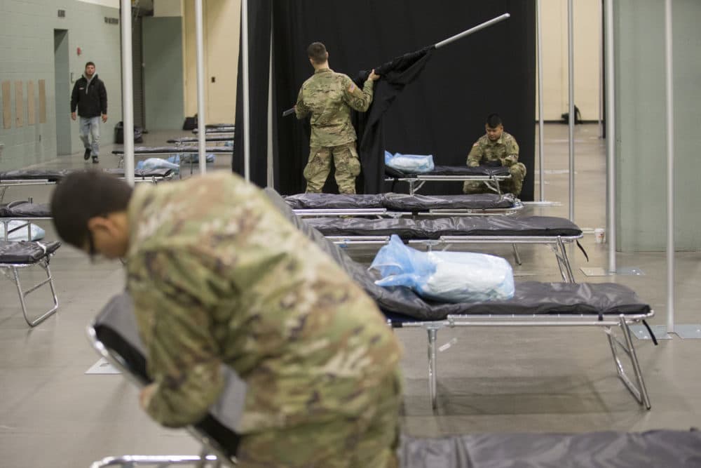 Members of the Massachusetts National Guard erect a medical field hospital at the DCU Center in Worcester for the expected influx of patients due to the COVID-19 pandemic. (Nicolaus Czarnecki/MediaNews Group/Boston Herald)