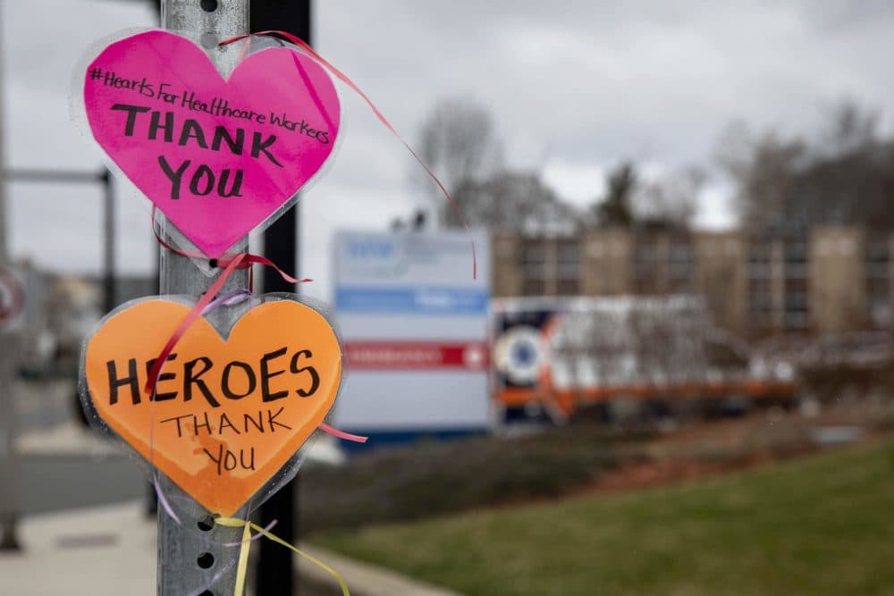 A message left on a street signpost by the Melrose Wakefield Hospital with the hashtag #HeartsForHealthcareWorkers, says &quot;Thank you.&quot; (Robin Lubbock/WBUR)