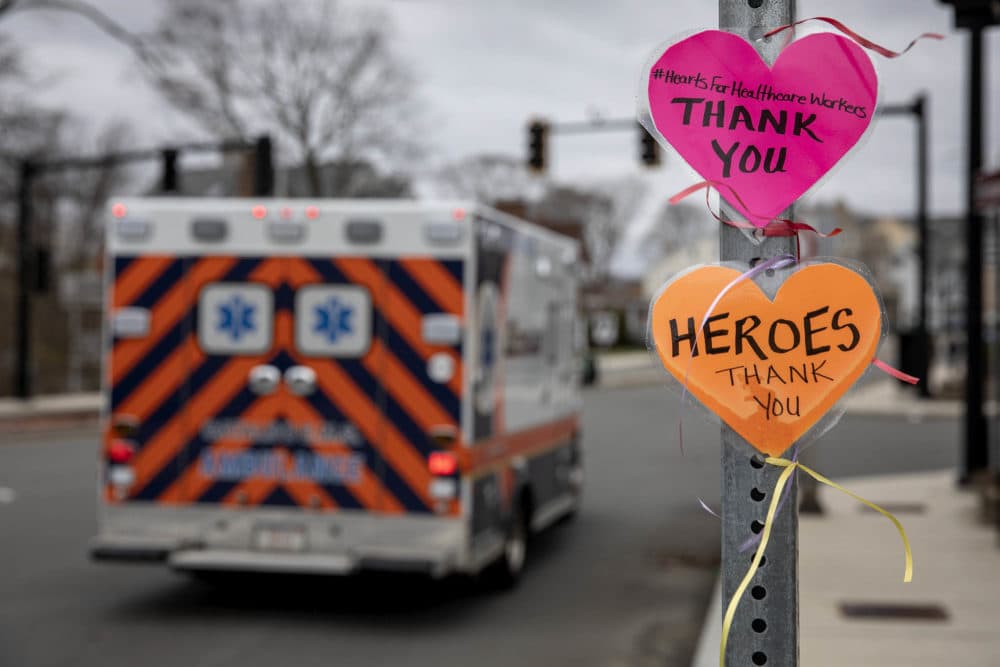 A message left on a street signpost by the Melrose Wakefield Hospital with the hashtag #HeartsForHealthcareWorkers, says &quot;Thank you.&quot; (Robin Lubbock/WBUR)
