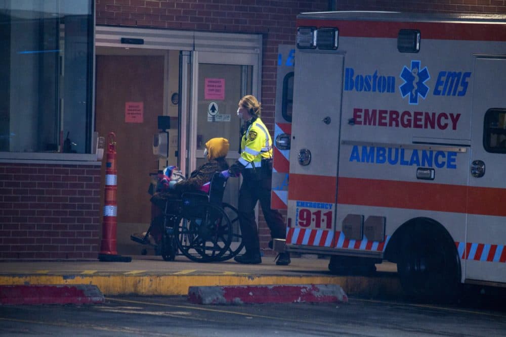 Boston EMS wheels a patient into the emergency entrance at Boston Medical Center. (Jesse Costa/WBUR)