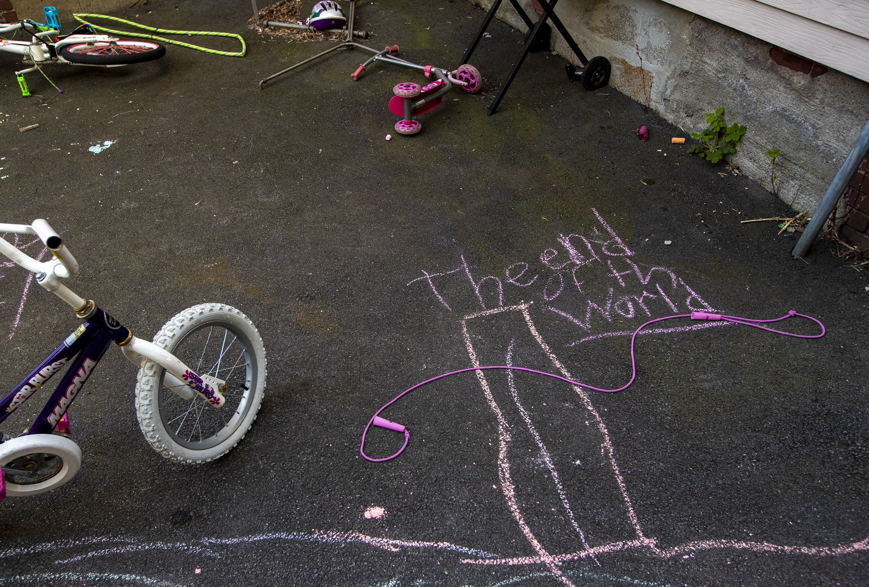A children’s chalk drawing in the backyard of a Somerville apartment house. (Jesse Costa/WBUR)