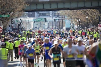 Hundreds of runners pour through Kenmore Square at the 2016 Boston Marathon. (Jesse Costa/WBUR)