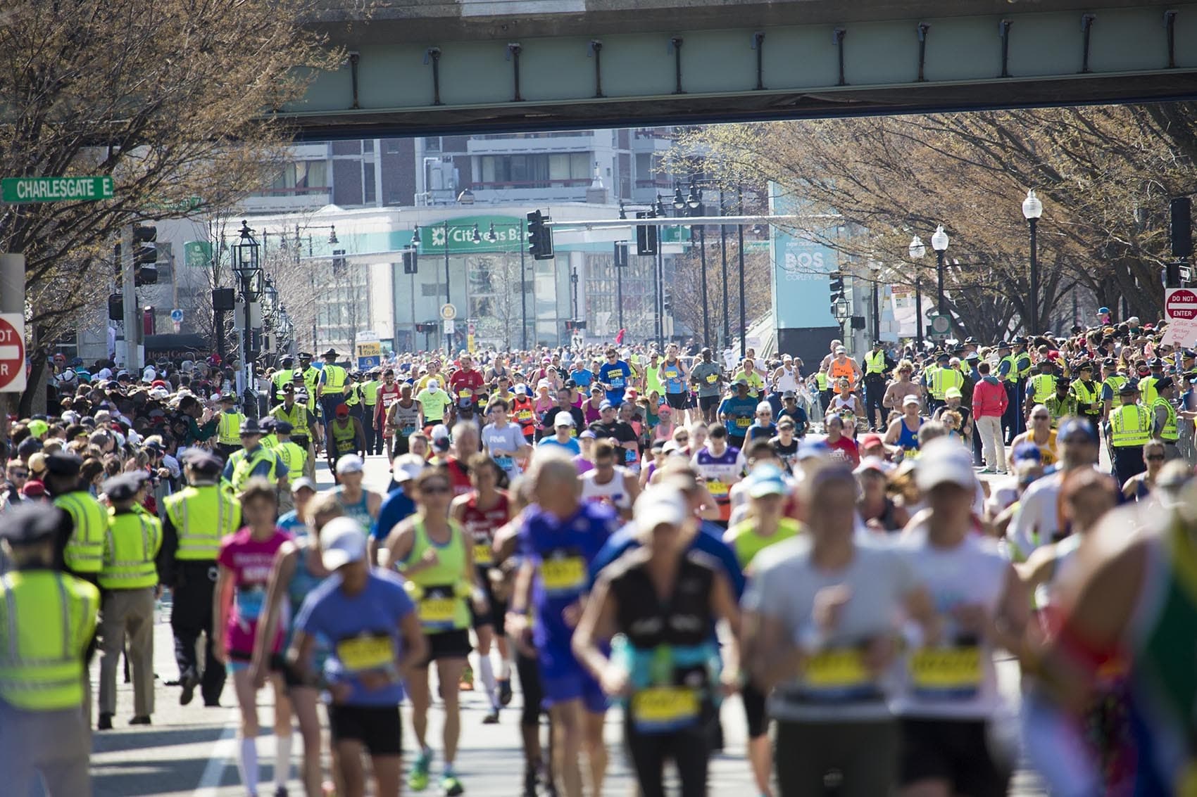 Hundreds of runners pour through Kenmore Square at the 2016 Boston Marathon. (Jesse Costa/WBUR)
