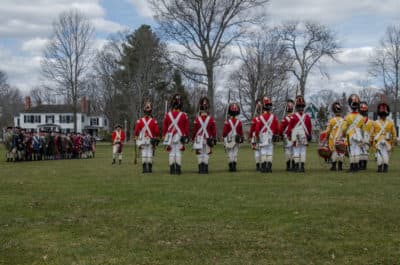 The Lexington Minute Men are confronted by British forces during the 2018 dress rehearsal of the Patriots Day reenactment. (Sharon Brody/WBUR)