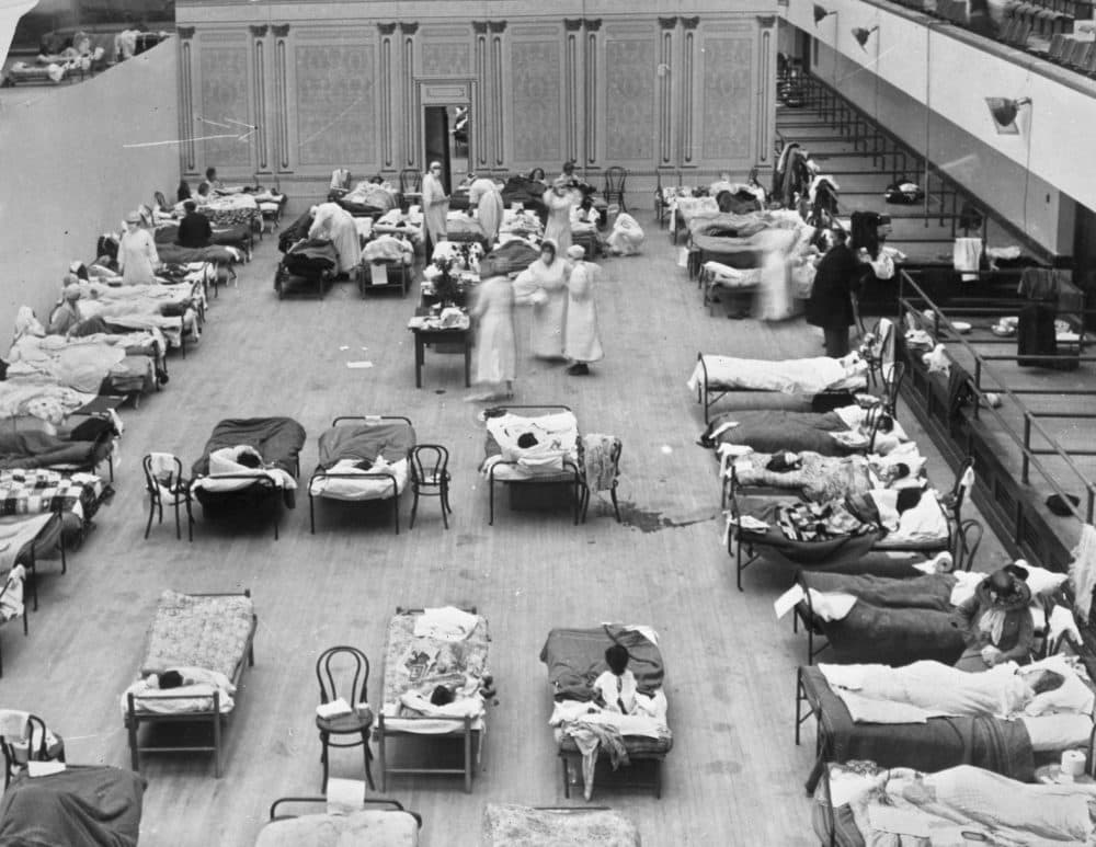 In this 1918 photo made available by the Library of Congress, volunteer nurses from the American Red Cross tend to influenza patients in the Oakland Municipal Auditorium, used as a temporary hospital. (Edward A. &quot;Doc&quot; Rogers/Library of Congress via AP)