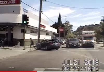 In this Saturday, July 21, 2018 frame from patrol car video released by the Los Angeles Police Department suspect Gene Evin Atkins runs into a Trader Joe's market after crashing his car at the end of a chase and firing rounds at officers pursuing him in Los Angeles. A store worker killed in a gunbattle before Atkins took hostages in a crowded supermarket was hit by a police officer's bullet, Police Chief Michel Moore said Tuesday. (LAPD via AP)