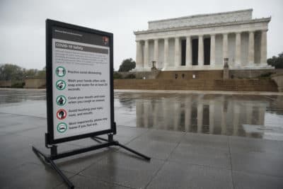 A sign about COVID-19 safety is posted at the Lincoln Memorial in Washington. (Carolyn Kaster/AP)