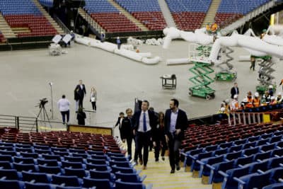 Gov. Gavin Newsom, front left, accompanied by Jason Kenney, front right, deputy director of the Real Estate Services Division of the Department of General Services, tours Sleep Train Arena, the former home of the NBA's Sacramento Kings basketball team in Sacramento, Calif., Monday, April 6, 2020. The arena is being transformed into a 400-bed emergency field hospital to help deal with the coronavirus outbreak. (Rich Pedroncelli/AP)