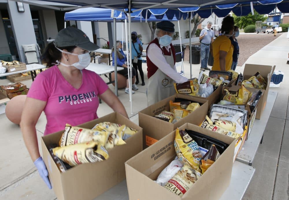 Food banks across the country are reporting a surge in demand from families impacted by the coronavirus pandemic. (Ross D. Franklin/AP)