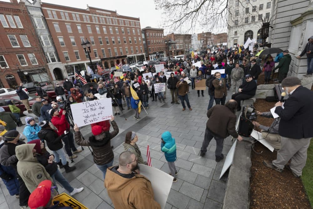 People attend a demonstration against the government mandated lockdown due to concerns about COVID-19 at the State House, Saturday, April 18, 2020, in Concord, N.H. (AP Photo/Michael Dwyer)