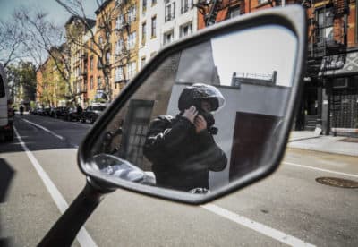 Eddie Song, a Korean American entrepreneur, prepares to ride his motorcycle wearing a jacket over extra body padding while equipped with video cameras, Sunday April 19, 2020, in East Village neighborhood of New York. After being blamed for causing the coronavirus outbreak in a recent assault, Song routinely wears the extra gear for extra safety. (AP Photo/Bebeto Matthews)