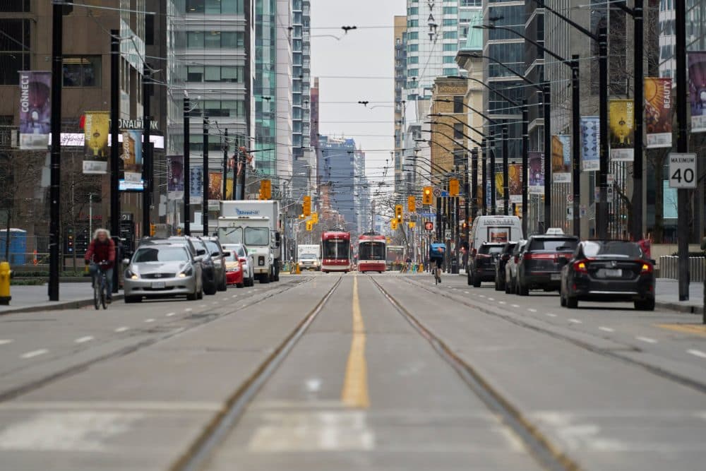 Only a few vehicles line the streets of downtown Toronto, Ontario on March 24, 2020. (GEOFF ROBINS/AFP via Getty Images)