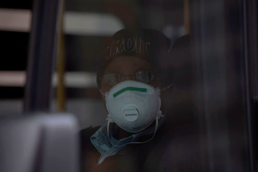 A bus driver for DDOT bus line in Detroit, Michigan, poses for a portrait while wearing her protective mask on March, 24, 2020. (Seth Herald/AFP/Getty Images)