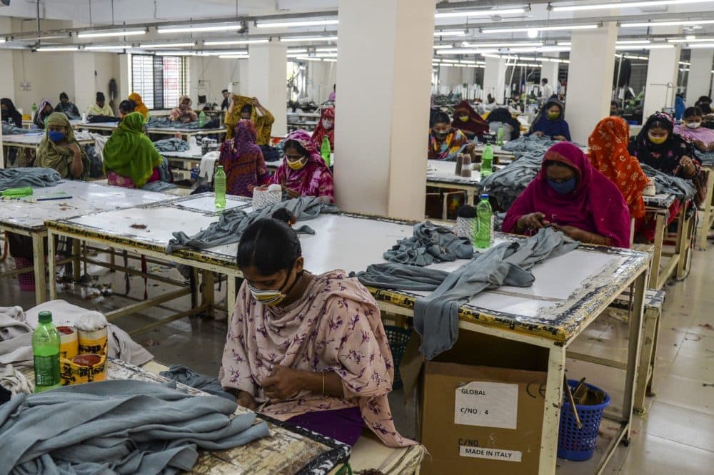 Garment workers wearing face masks work in a factory during a government-imposed lockdown as a preventative measure against the COVID-19 coronavirus on the outskirts of Dhaka on April 7, 2020. (Munir Uz Zaman/AFP/Getty Images)