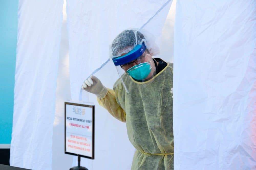 A nurse practitioner awaits his next patient at a mobile COVID-19 testing station in a public school parking area in Compton, California, on April 28, 2020. (Robyn Beck/AFP/Getty Images)