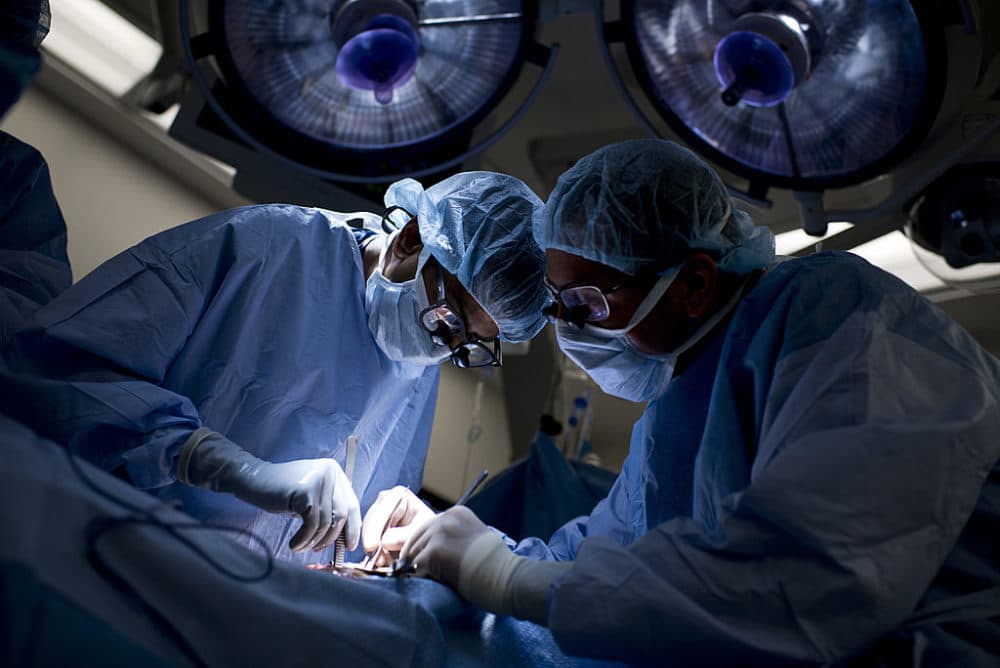 Dr. Niraj Desai (left) sews in a kidney to a recipient patient during a kidney transplant at Johns Hopkins Hospital June 26, 2012 in Baltimore, Maryland. (Brendan Smialowski/AFP/Getty Images)
