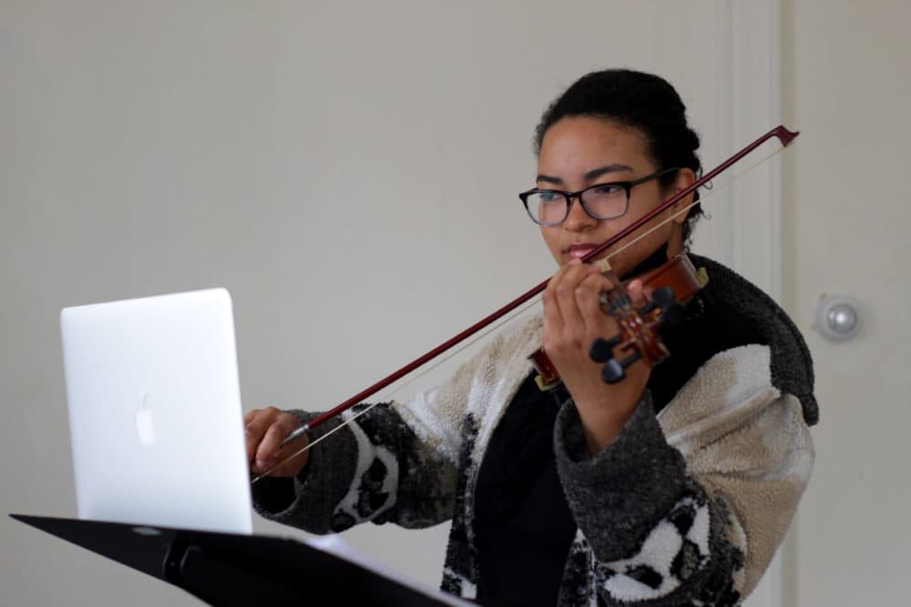 Brittany Kinch, 24, of Jamaica Plain takes a violin lesson virtually during quarantine. (Courtesy Sajada Domino)