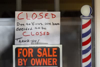 &quot;For Sale By Owner&quot; and &quot;Closed Due to Virus&quot; signs are displayed in the window of a business in Grosse Pointe Woods, Mich., on April 2. (Paul Sancya/AP)