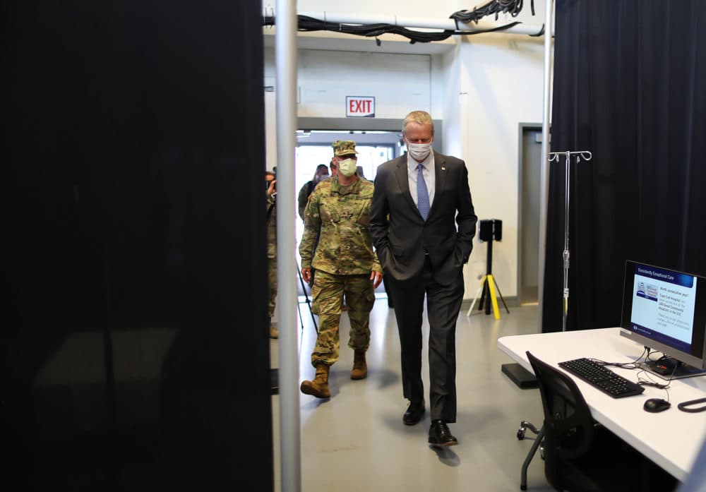 Gov. Charlie Baker and Lt. Gov. Karyn Polito joined the Massachusetts National Guard and Michael Lauf, president and CEO of Cape Cod Healthcare, as they toured a field medical station in a gymnasium at Joint Base Cape Cod on Tuesday. (John Tlumacki/Globe Staff/pool)