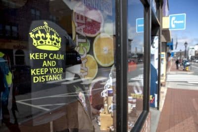 A T-shirt in the window of the iD art GraphicsShop on Moody Street, Waltham, says &quot;Keep Calm And Keep Your Distance.&quot; (Robin Lubbock/WBUR)
