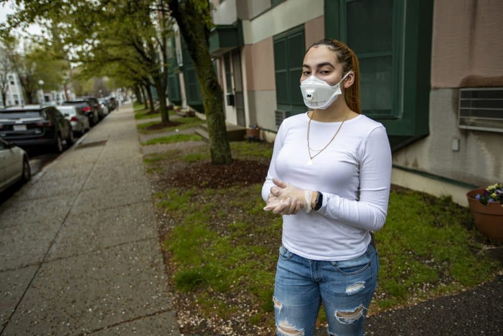 Melany Cardona in the protective personal equipment she wears for work. (Jesse Costa/WBUR)