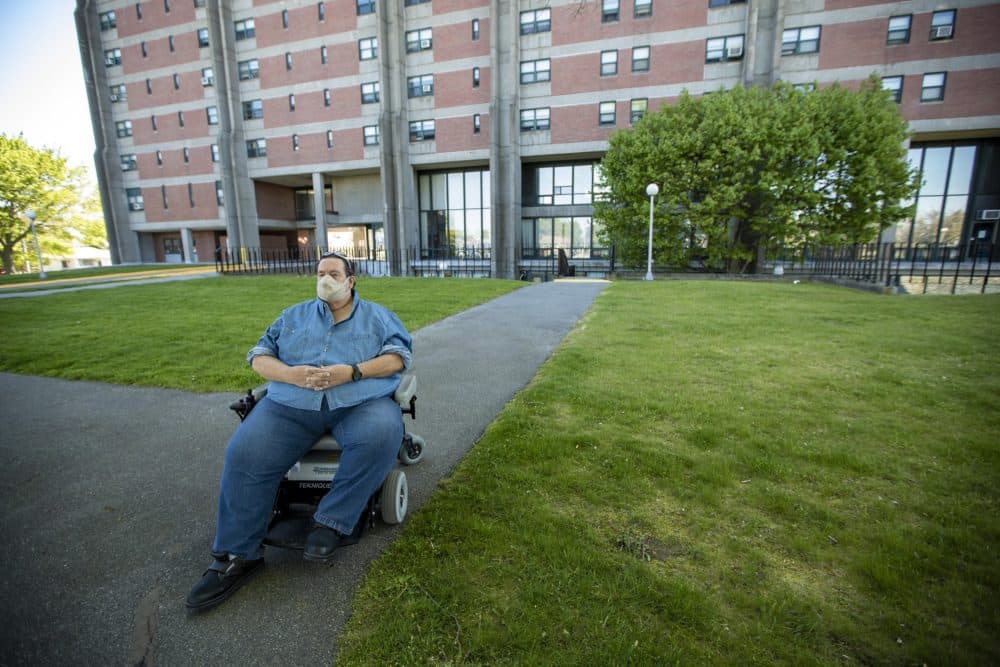 David Underhill sits outside of the Cardinal Medeiros Towers in Fall River. He has been a public housing tenant for 12 years and sits on the town's board of housing commissioners. (Jesse Costa/WBUR)
