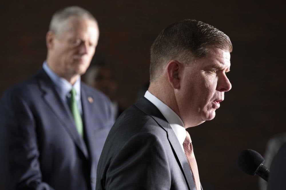 Boston Mayor Marty Walsh talks about the postponement of the Boston Marathon as Gov. Charlie Baker, left, looks on, during a news conference. (Michael Dwyer/AP)
