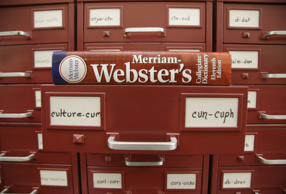 A Merriam-Webster dictionary sits atop their citation files for the 2014 word of the year, &quot;culture,&quot; at the dictionary publisher's offices in Springfield, Massachusetts. (Stephan Savoia/AP)