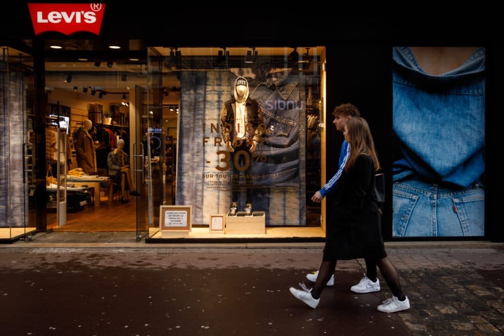 People walk in front of LEVI'S shop in the city of Caen, northwestern of France, on Nov. 29, 2019. (Sameer Al-Doumy/AFP via Getty Images)