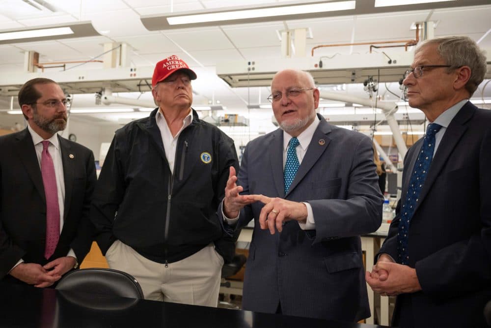 President Donald Trump (2nd L) stands next to US Health and Human Service Secretary Alex Azar (L), CDC Director Robert Redfield (2nd R), and CDC Associate Director for Laboratory Science and Safety (ADLSS) Dr. Steve Monroe during a tour of the Centers for Disease Control and Prevention (CDC) in Atlanta, Georgia, on March 6, 2020. (JIM WATSON/AFP via Getty Images)