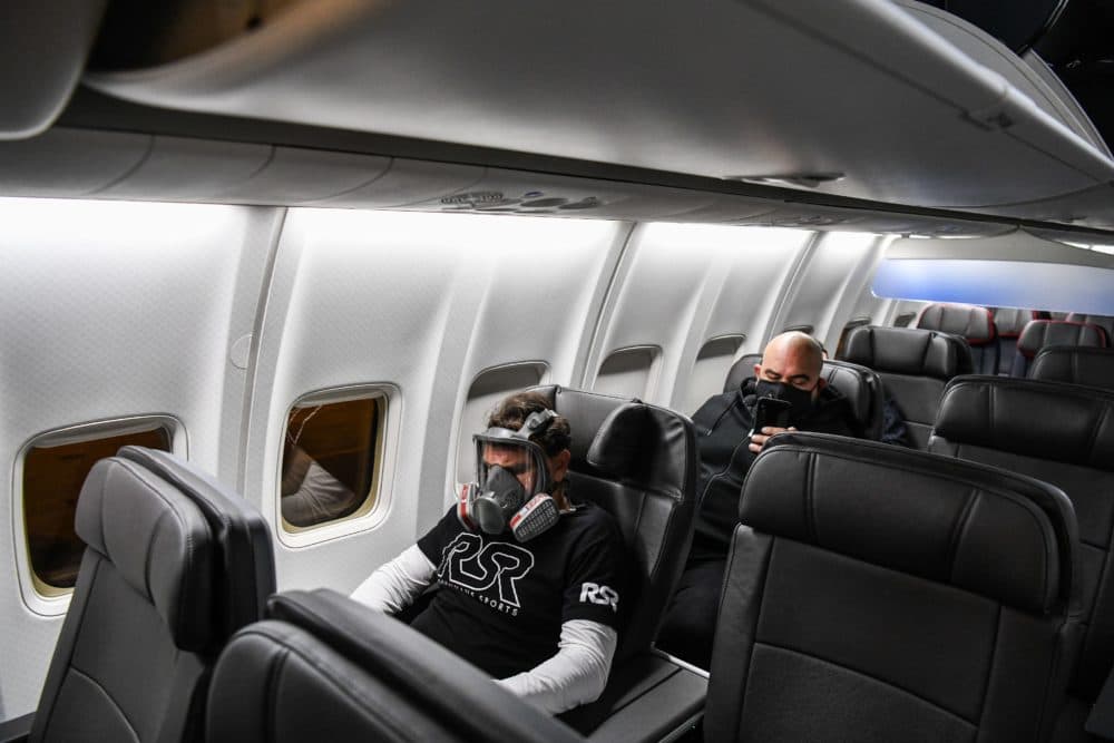 A man wears a gasmask as he travels in a flight from Miami to Atlanta in Miami, on April 23, 2020. (CHANDAN KHANNA/AFP via Getty Images)
