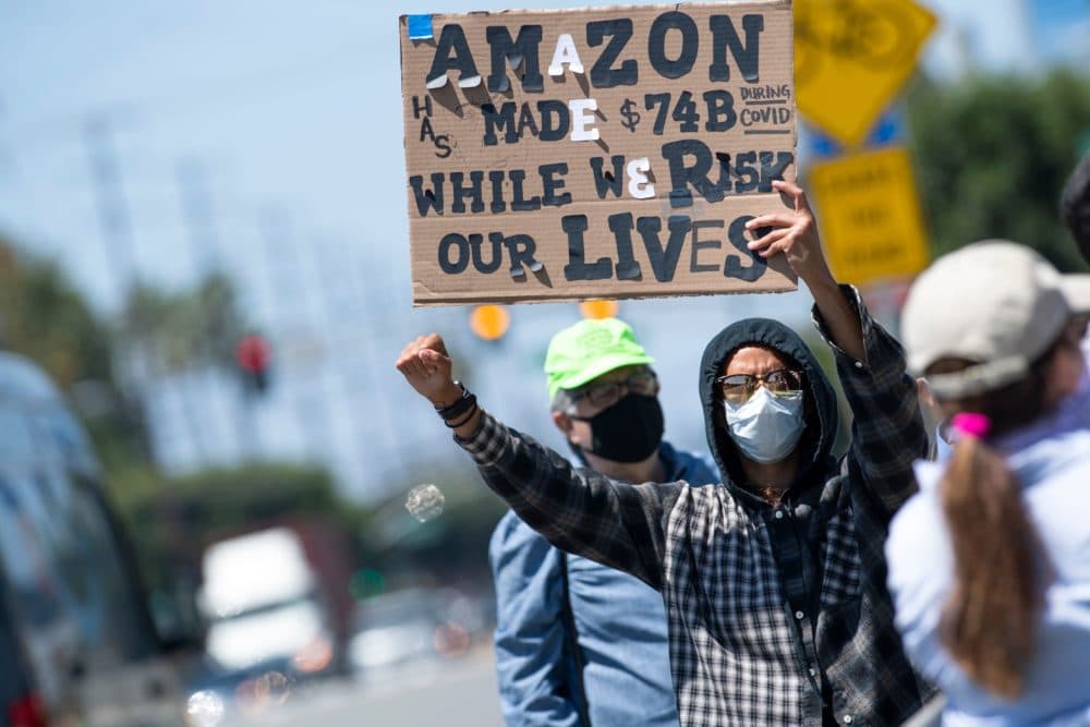 Workers protest the failure of their employers to provide adequate protections in the workplace of the Amazon delivery hub on National May Day Walkout/Sickout  amid the Covid-19 pandemic on May 1, 2020, in Hawthorne, California. (VALERIE MACON/AFP via Getty Images)