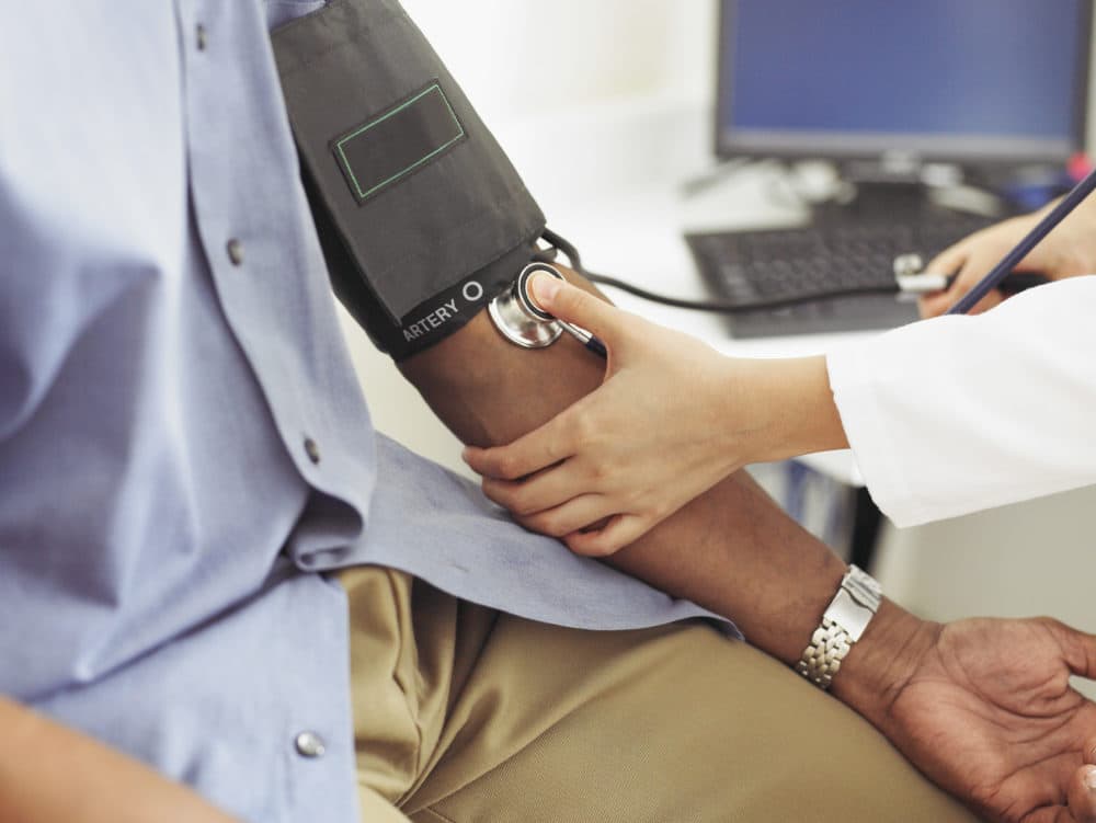 A doctor takes a patient's blood pressure. (Getty Images)