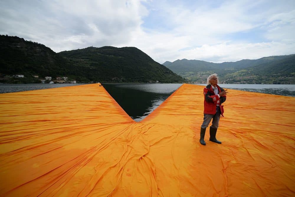 Artist Christo Vladimirov Javacheff walks on his monumental installation &quot;The Floating Piers&quot; he created with late Jeanne-Claude, on June 16, 2016, during a press preview at the lake Iseo, northern Italy. Some 200,000 floating cubes create a 3-kilometers runway connecting the village of Sulzano to the small island of Monte Isola on the Iseo Lake for a 16-day outdoor installation opening on June 18. (Filippo Monteforte/AFP/Getty Images)