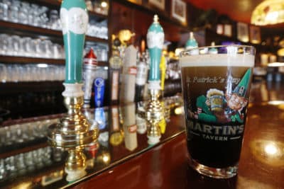 A glass go Guinness Stout rests on an an empty bar at a restaurant in the Georgetown area on March 17 in Washington. (Steve Helber/AP)