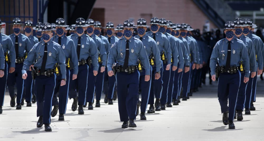 Some of the 240 new Massachusetts State Police troopers as they marched out of Gillette Stadium after Gov. Charlie Baker swore them in at a graduation ceremony. (Pool photo/Jonathan Wiggs/The Boston Globe)