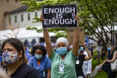 Hundreds of staff at the Massachusetts General Hospital participated in a kneel-in acknowledging the injustice of systemic and individual racism in America at the Bulfinch Lawn outside of the Wang Entrance of the hospital, June 5, 2020. (Jesse Costa/WBUR)