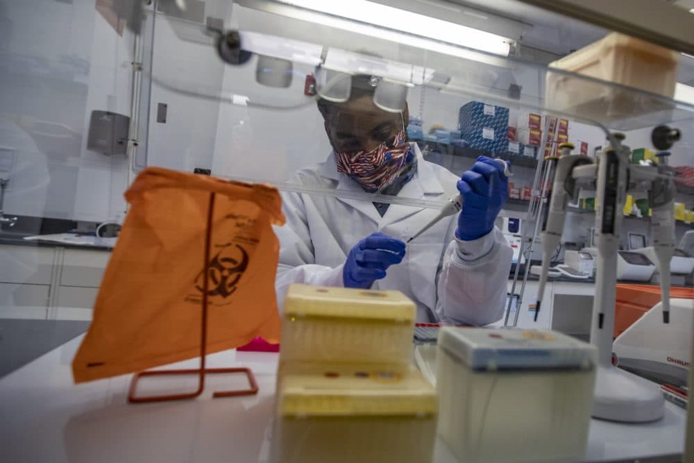 Sherlock Biosciences Research Associate Joel Mowatt in the lab. The Cambridge, Mass. company develops coronavirus tests using CRISPR and synthetic biology. (Jesse Costa/WBUR)