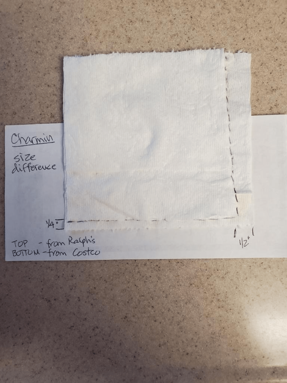 Melanie's size comparison of a square of Charmin Ultra Soft toilet paper from a newer package on top of a square from an older package.