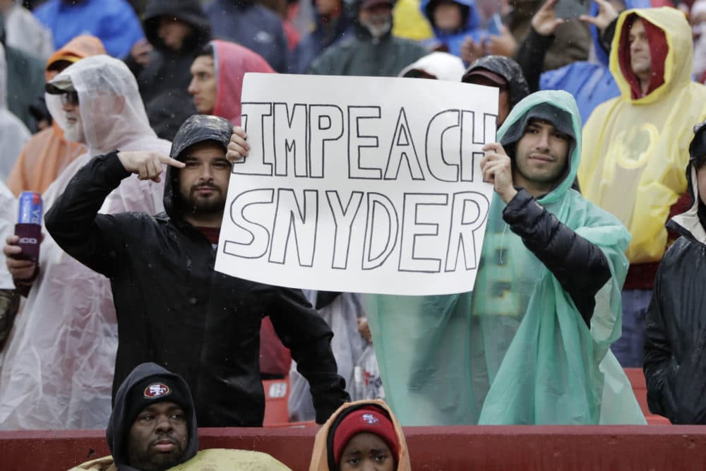 Spectators hold a sign disapproving of Washington D.C.'s NFL team owner Dan Snyder in 2019. (Julio Cortez/AP)