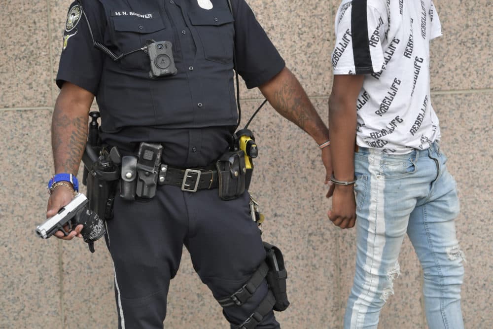 Atlanta Police officers detain a man after finding a hand gun in his backpack during a protest, Friday, May 30, 2020 in Atlanta. The protest started peacefully earlier in the day before demonstrators clashed with police. (Mike Stewart/AP)