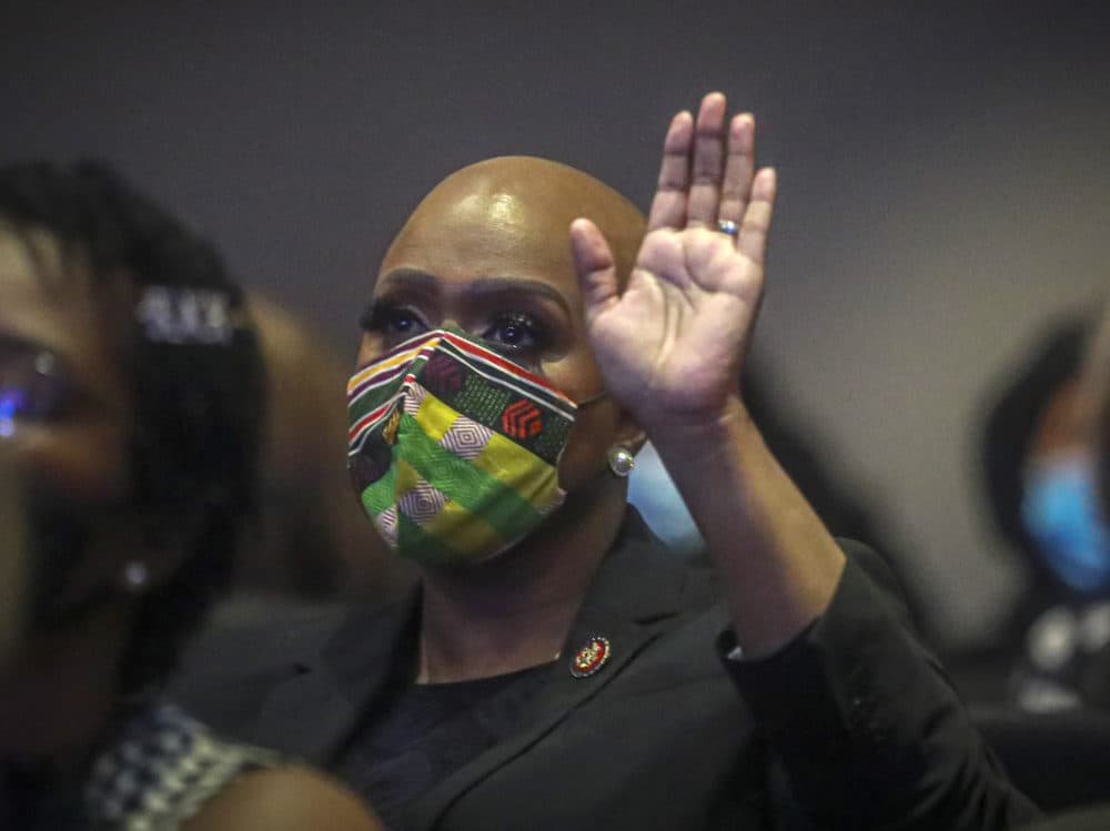 U.S. Rep. Ayanna Pressley of Massachusetts raises her hand during a memorial service for George Floyd at North Central University, on Thursday, June 4, 2020, in Minneapolis. Hollywood celebrities, musicians and political leaders gathered in front of the golden casket of George Floyd whose death at the hands of police sparked global protests. (AP Photo/Bebeto Matthews)