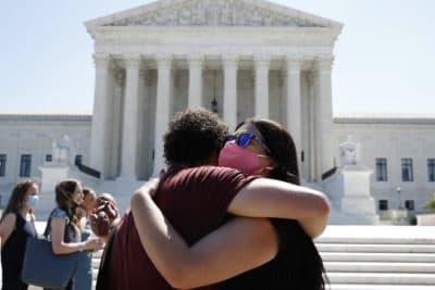 Anti-abortion protesters hug goodbye outside the Supreme Court on Capitol Hill in Washington, Monday, June 29, 2020. (Patrick Semansky/AP)