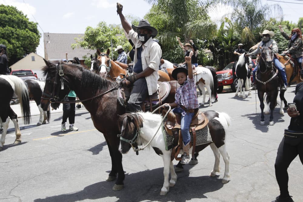 Members of the Compton Cowboys join a demonstration Sunday June, 7, 2020 in Compton, Calif., during a protest over the death of George Floyd who died May 25 after he was restrained by Minneapolis police. (AP Photo/Marcio Jose Sanchez)
