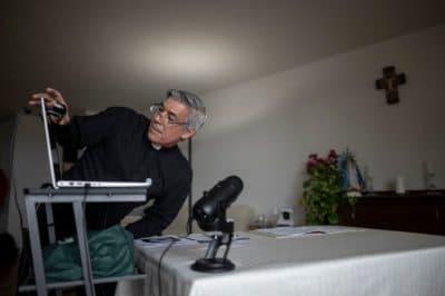 Fabian Arias, a Lutheran pastor with Saint Peter's Church in Manhattan, prepares his Sunday services via internet live stream on May 24, 2020 in the streets in Harlem neighbourhood of Manhattan in New York. (JOHANNES EISELE/AFP via Getty Images)