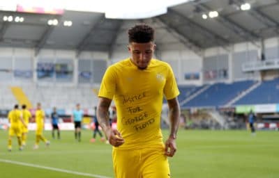 Dortmund's English midfielder Jadon Sancho wears a &quot;Justice for George Floyd&quot; shirt after scoring his team's third goal during a Bundesliga match on May 31, 2020. (Lars Baron/POOL/AFP via Getty Images)