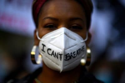 A woman wears a mask reading &quot;I can't breathe&quot; in Madrid, on June 7, 2020, during a demonstration against racism and in solidarity with the Black Lives Matter movement, in the wake of the killing of George Floyd. (GABRIEL BOUYS/AFP via Getty Images)