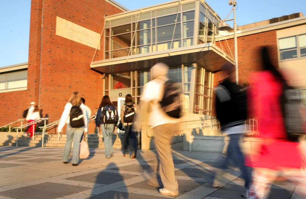 In this file photo, students walk outside Framingham High School at the start of their school day. (Melanie Stetson Freeman/The Christian Science Monitor via Getty Images)